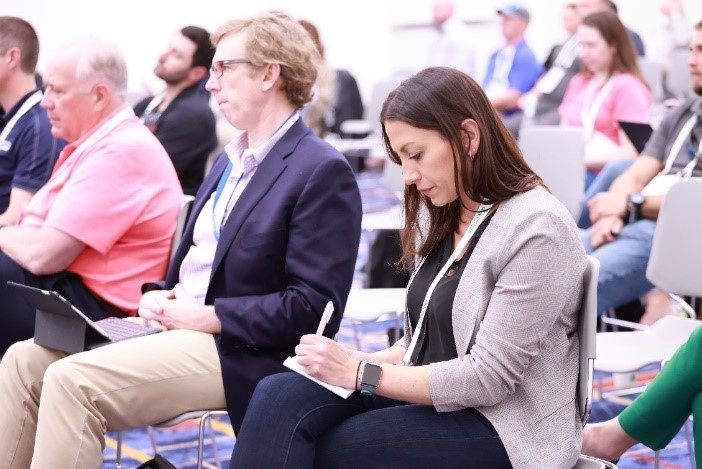 Picture - People are taking notes during a conference at WasteExpo 2024.