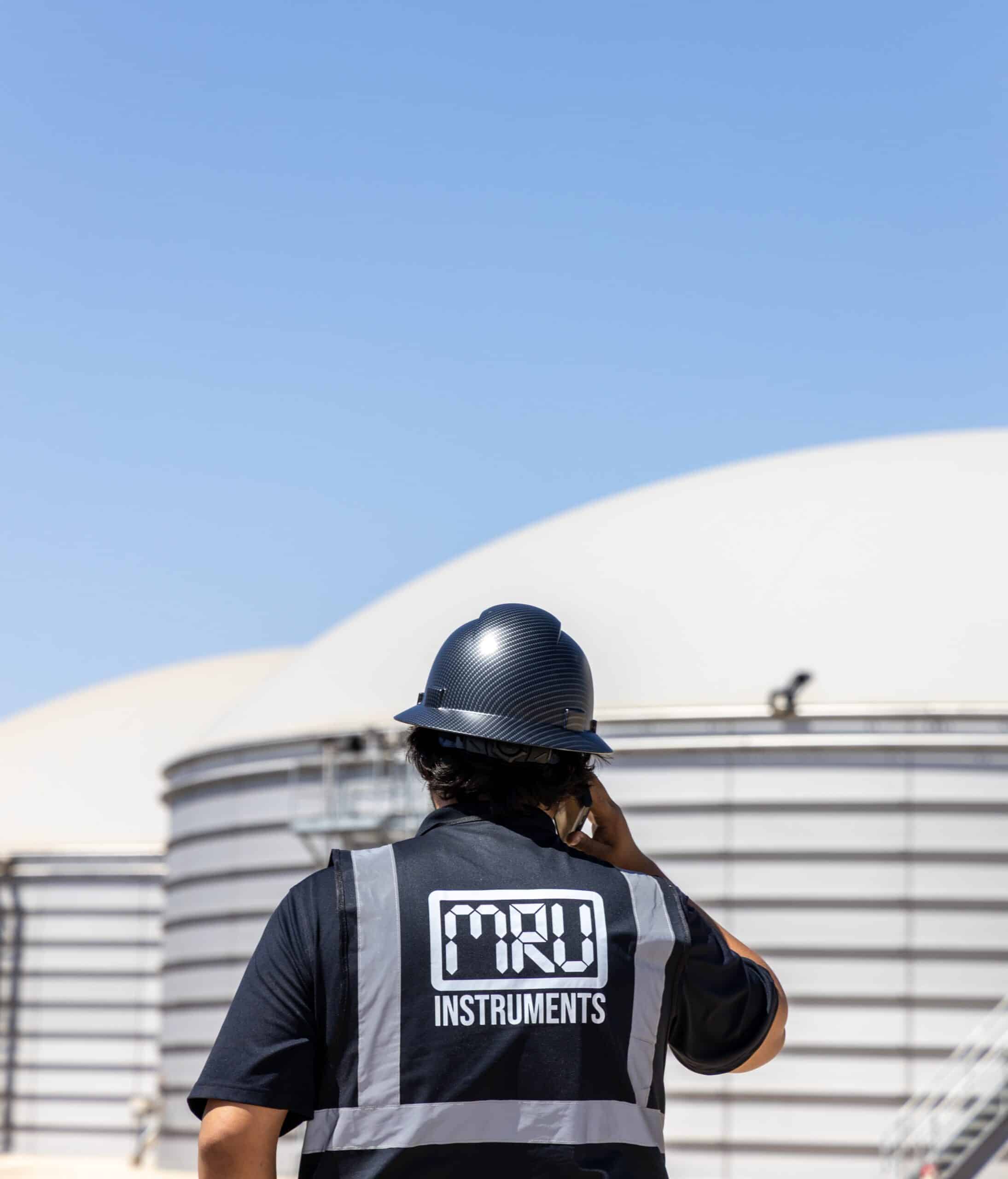Picture - An MRU employee looking at a biogas tank.